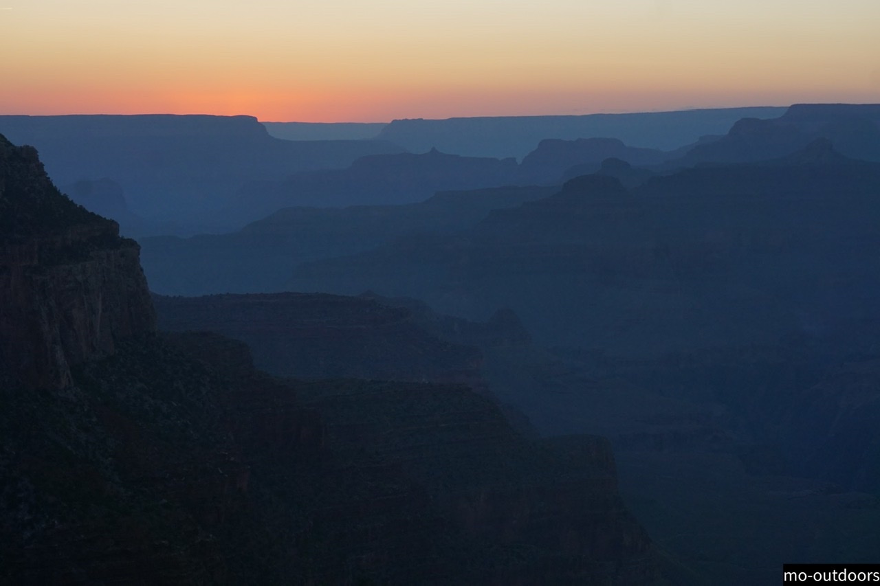 Grand Canyon at sunset with many different shades of orange and blue